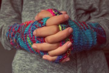 Interlaced fingers and knit arm warmers